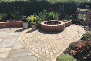  Natural stone paving to a curve with brick built well and planting.