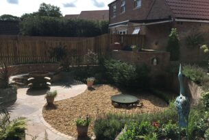  Garden fire pit and curved brick built seating.