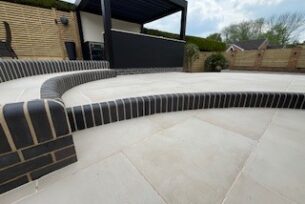  Porcelain paving with curved blue bricks as steps.