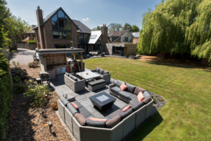  Cedar built outdoor kitchen with granite worktop and stainless BBQ and outdoor sofas.