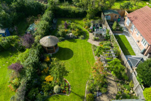  Aerial view of a traditional and natural garden design using a timber pergola paths and natural paving.