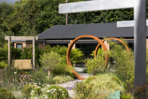  Contemporary garden design showing CorTen steel circles and wild planting.