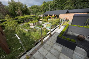  Modern planting with a water rill and Corten steel rings creating a garden sculpture.