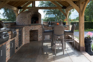  Full outdoor kitchen with a brick built pizza oven, granite worktop and brick built BBQ