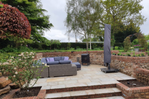  Split levels create outdoor seating areas using brick and cobbled walling and natural stone paving.
