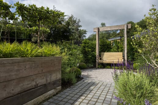 Modern garden design in York with swing seat set among colourfull planting