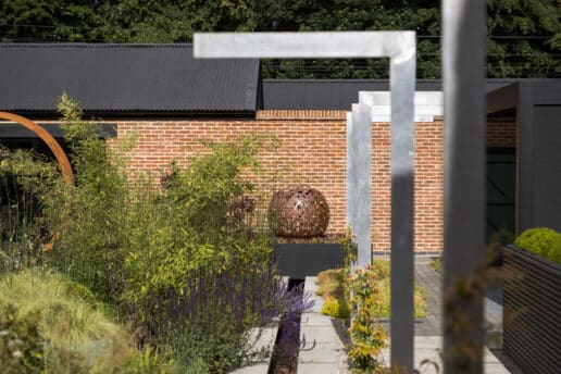 Modern garden in York involving a water Rill and sculptural art with planting for colour.