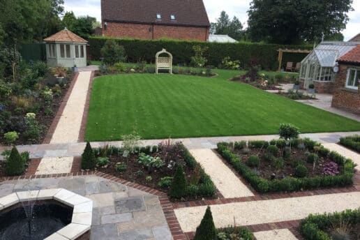 Large Formal garden transformation involving a large lawn, plated beds and formal paths
