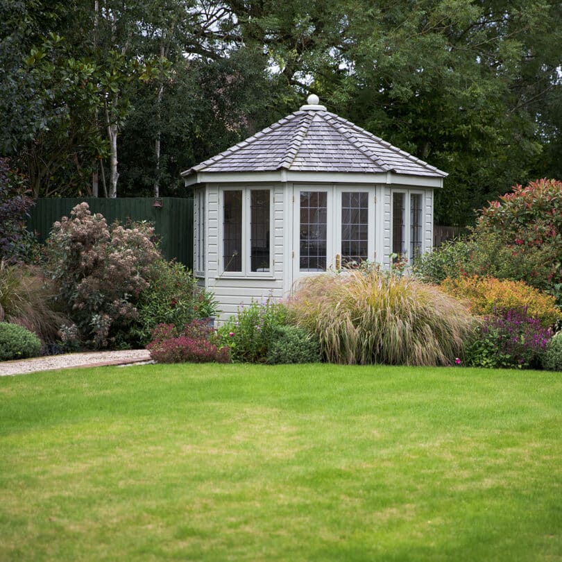 Traditional garden design with planting and a summerhouse