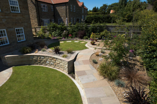 Stone walling used to create a terraced garden with curves